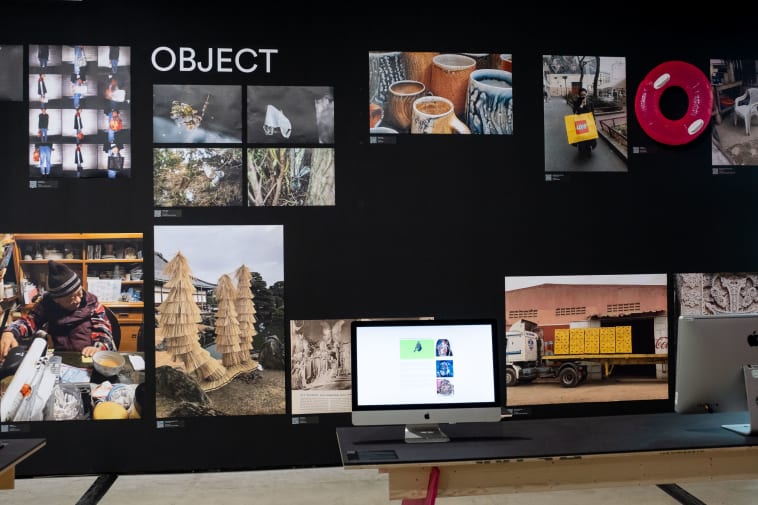 Black wall covered with images and title 'objects'