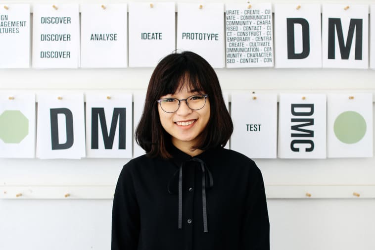 Student Ngoc (Sam) Trieu, BA (Hons) Design Management, in front of her graphic design installation at London College of Communication