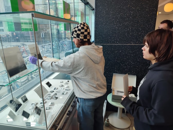 Two students installing items in a display case