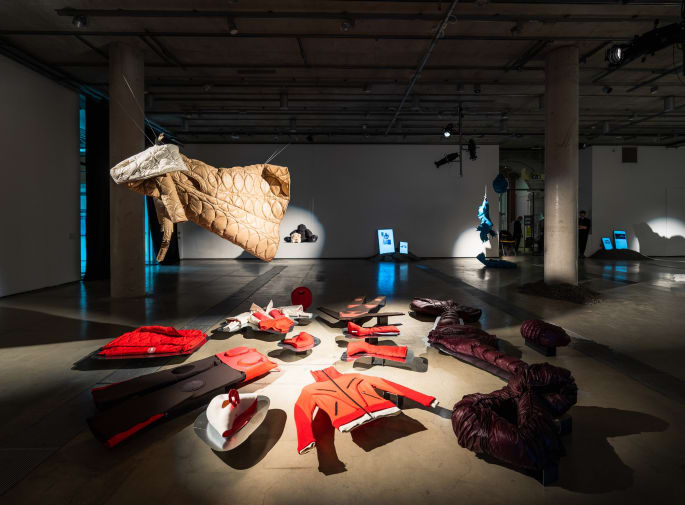 A shot of garments installed inside an exhibition space