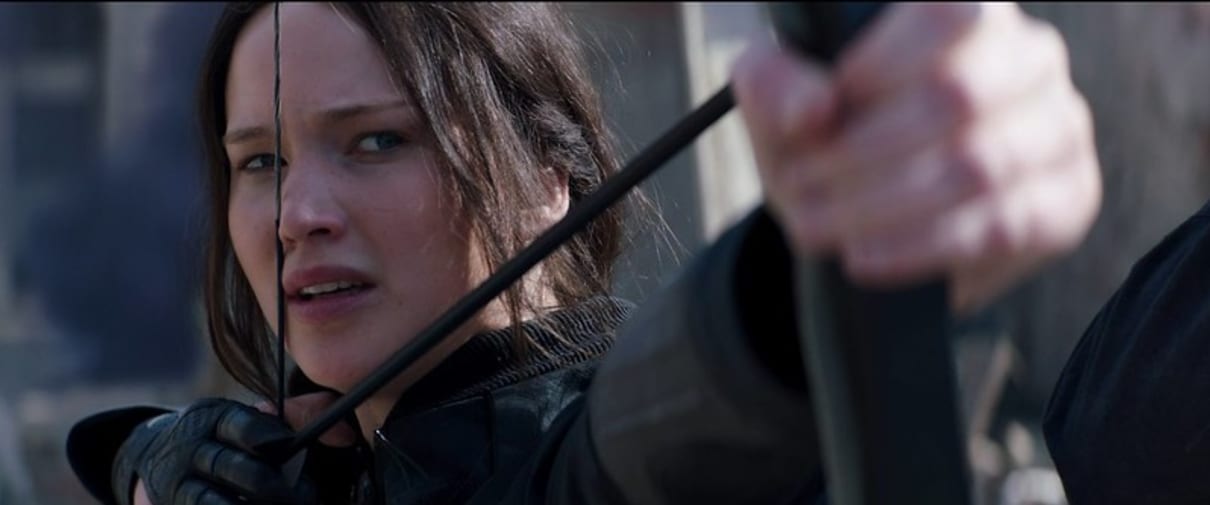 Actor Jennifer Lawrence holding a bow and arrow as Katniss Everdeen in film The Hunger Games: Mockingjay - Part 2 (2015).