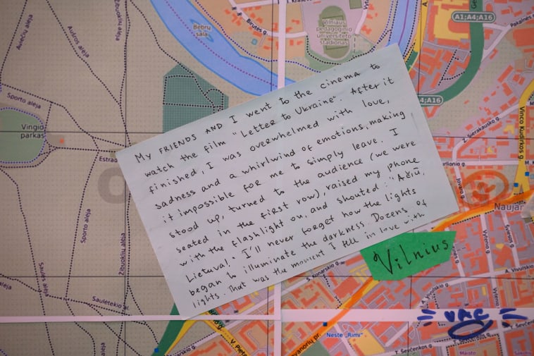 Close-up map of Vinius with a handwritten green label with the city name, and a hand-written post-it note stuck on sharing the feelings of a Ukranian in the city.
