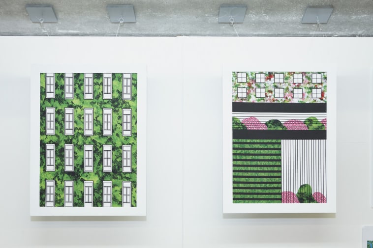 2 paintings in white frames on a white wall showing buildings and symmetrical designs integrated with the green of nature