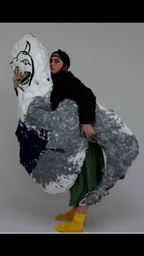 Woman holding large textile sculpture