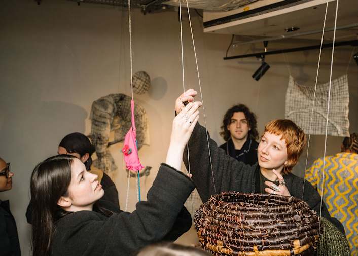 An image of students interacting with an art installation