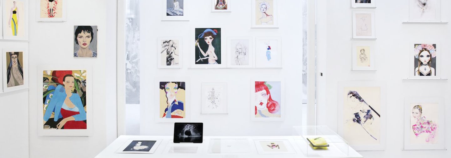 Image of previous DRAWFASHION exhibition with illustrations hanging on the wall