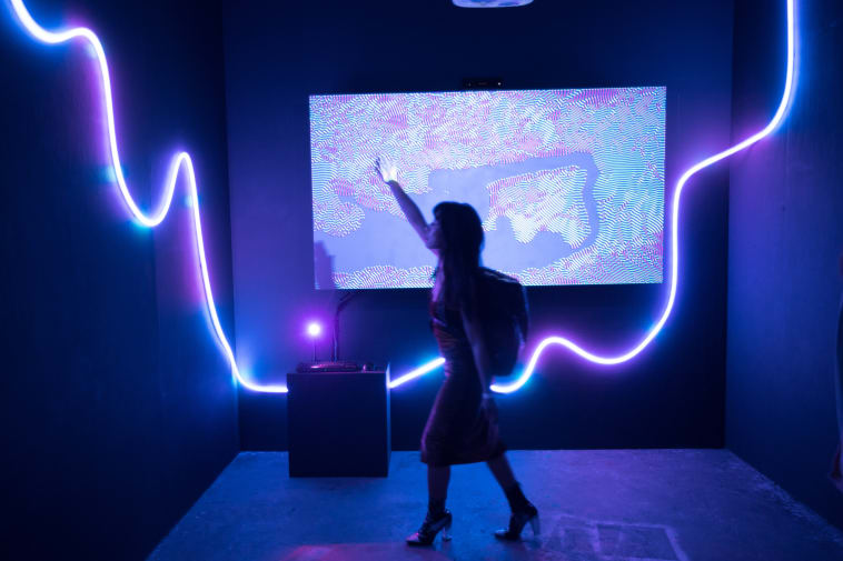 A digital installation lit in purple