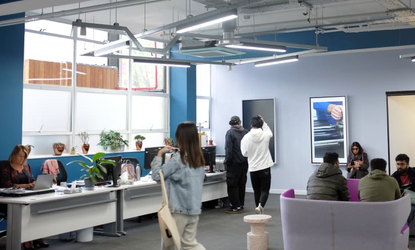 Students standing and walking in the LCC Information Centre