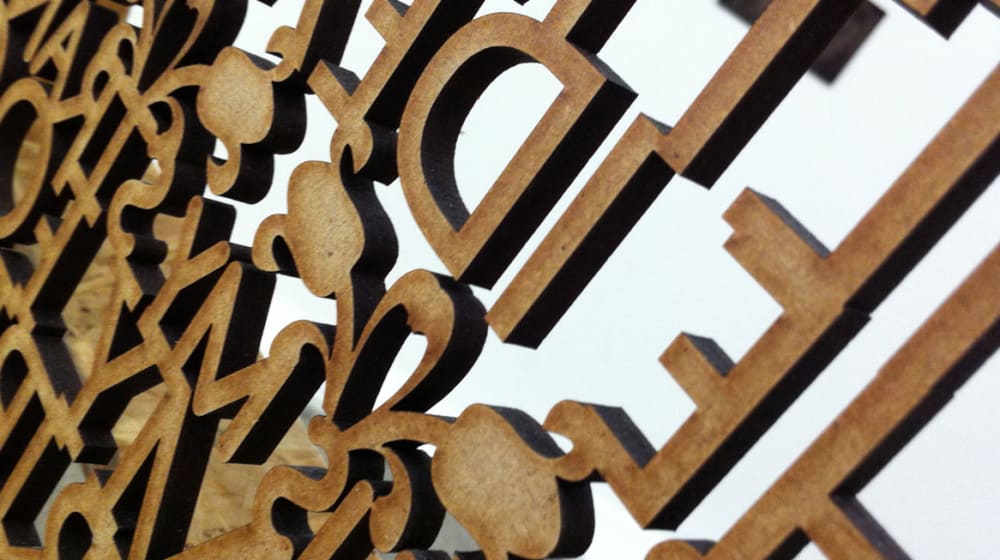 Rear view of wooden cut out letters against white background