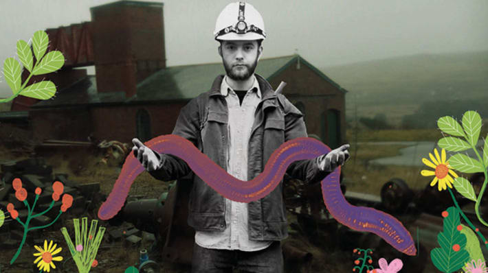 Photograph of a man wearing a hardhat holding an illustrated worm and surrounded by illustrations of flowers and leaves.