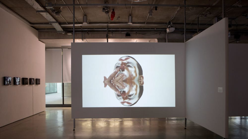 Image of a clown projected onto a large wide wall