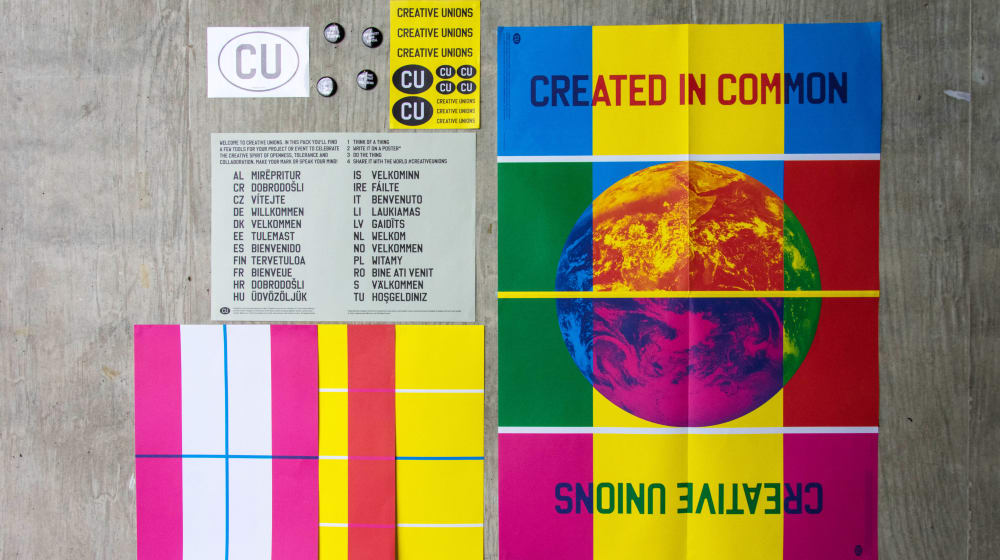 A number of Creative Unions posters laid out on the ground