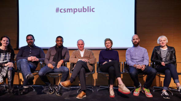 Group of people sitting in a row on a stage