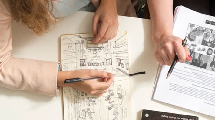 Researchers making notes at a desk
