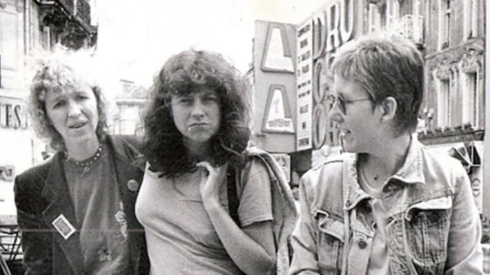 Black and white photo of Lindsay Cooper with two woman walking down a street.