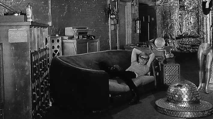 Black and white image of Andy Warhol in his studio