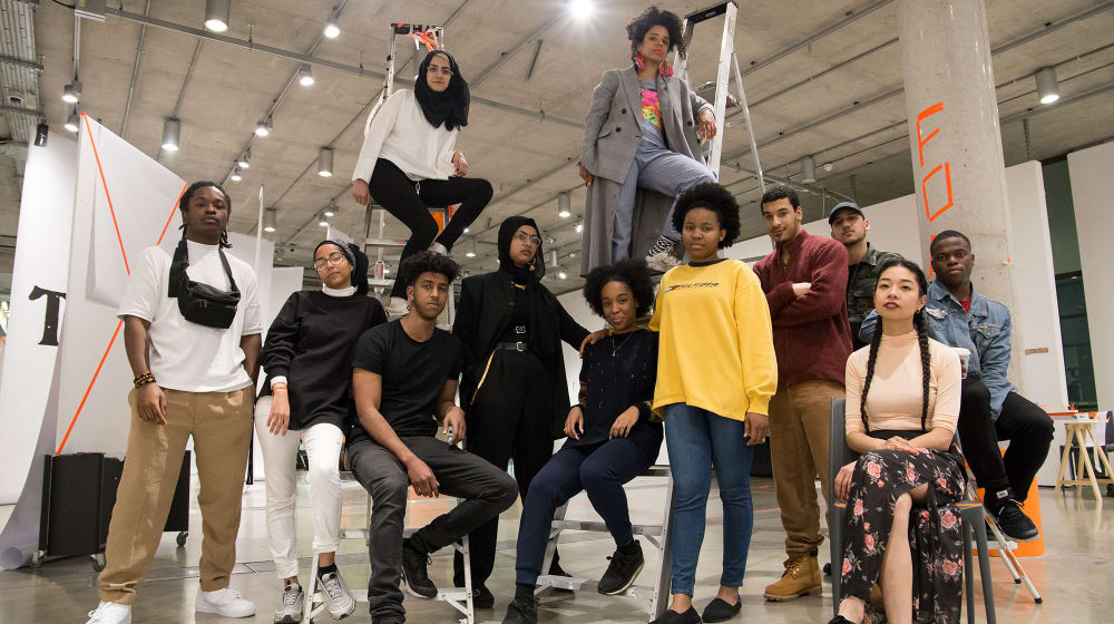 A group of people some sitting, some standing in the Lethaby Gallery