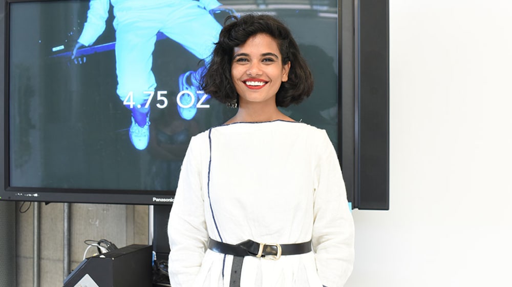 Lady presenting in front of TV