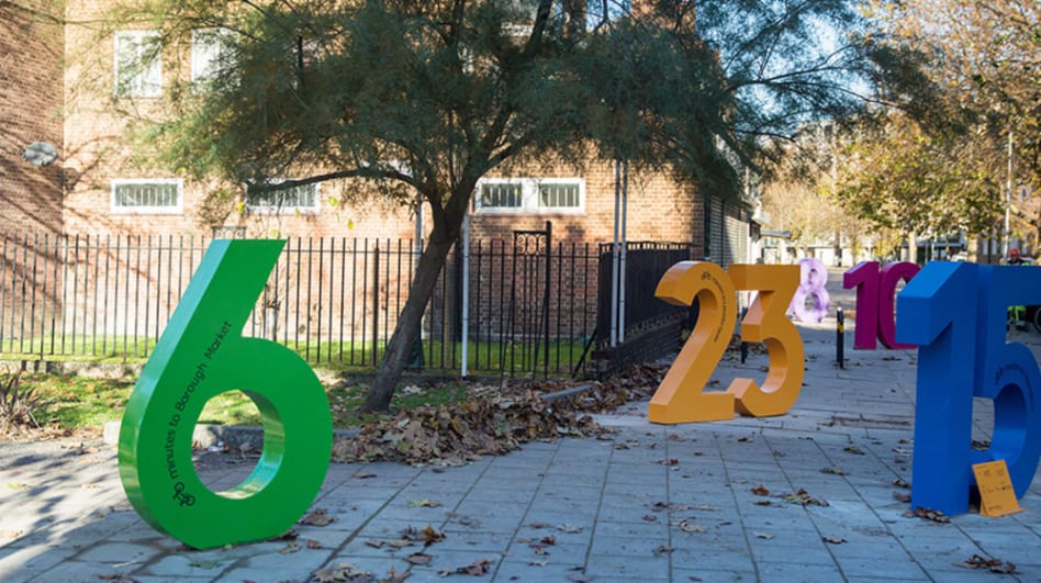 An installation of large colourful numbers designed by LCC graduates and placed around the Santander Cycle Hire docking station.