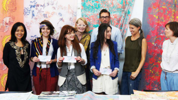 A group of people stood in front of a brightly coloured backdrop