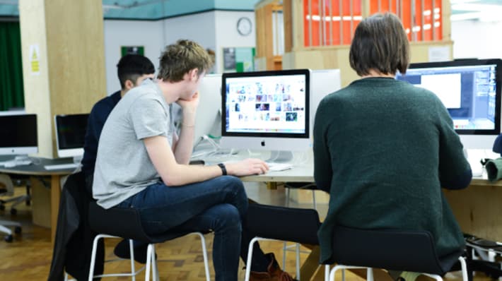London College of Communication students sitting at iMacs