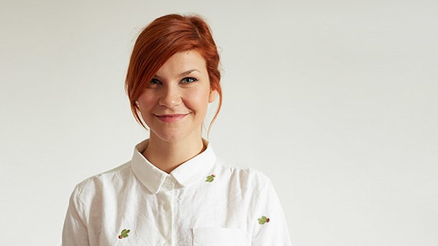 Photo head-shot of Lisa Matzi, wearing a white shirt with green cacti.