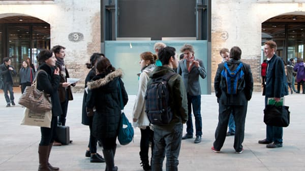 Visitors looking around the entrance of Central Saint Martins which is set in a Victorian grain store