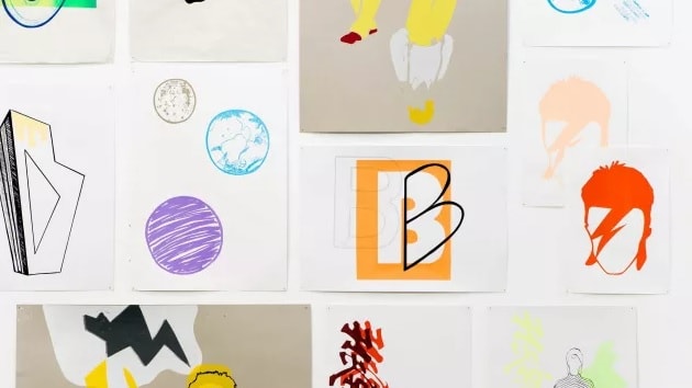 Photo of colourful pieces of art hanging on a white background