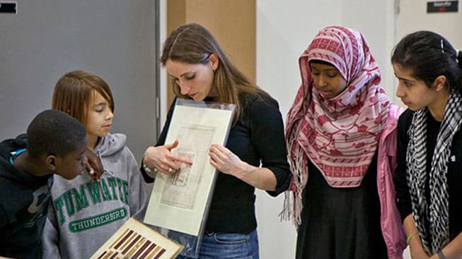 Judy Willcocks, Head of the Museum and Study Collection at Central Saint Martins, showing students a paper archive