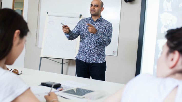 Photo of a man talking in front of a class
