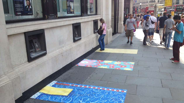 Colourful patterned paving stones around cash machines