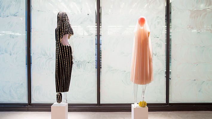 Two mannequins dressed in abstract garments on display in the Lethaby Gallery