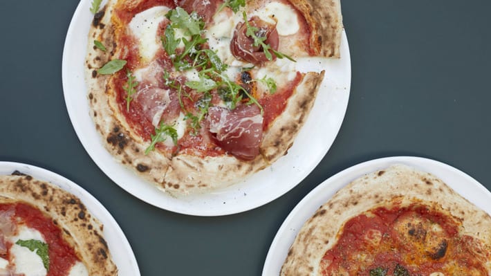 Three pizzas on a table