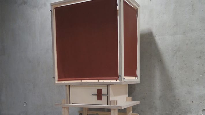 A wooden box with maroon panels