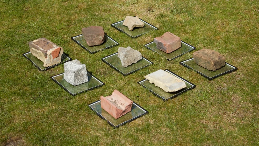 bricks on glass plates on top of grass