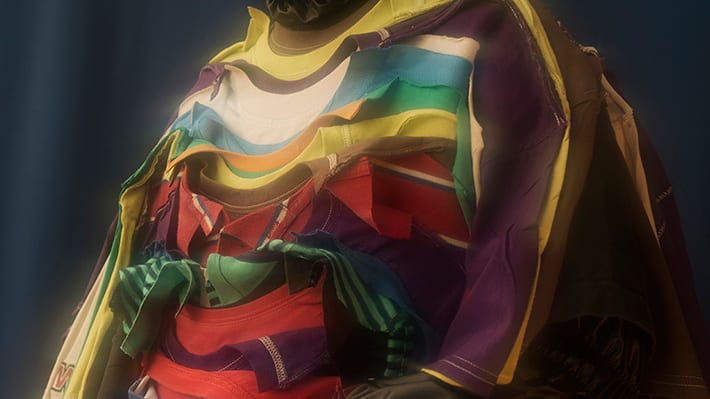 Detail of a garment which is made up of a number of tops overlapping