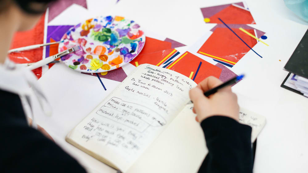 Student writing in a notebook