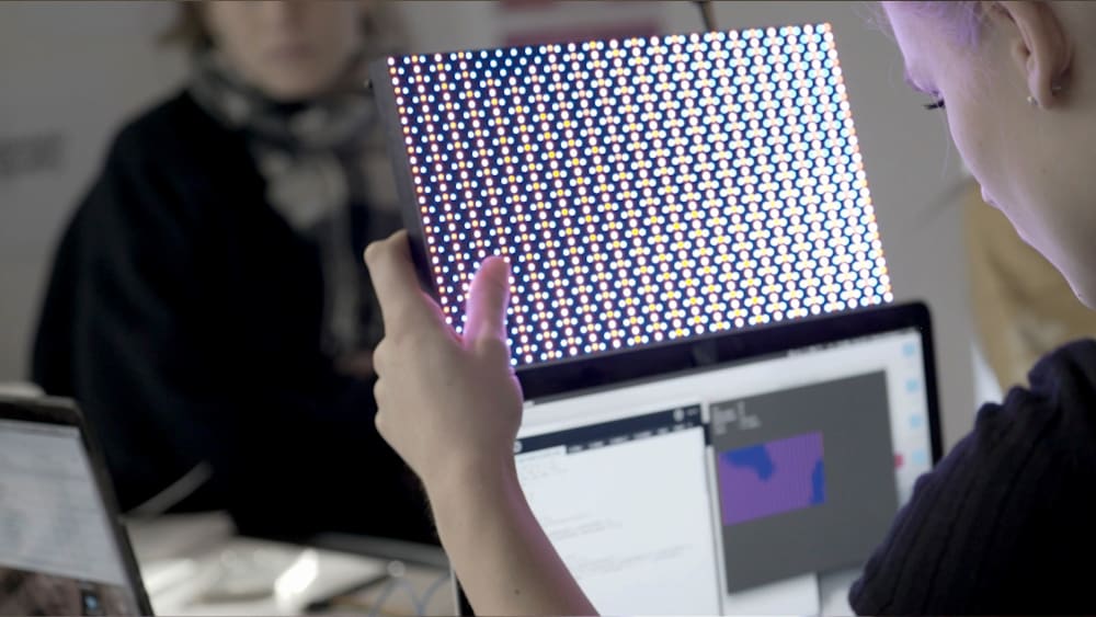 Student holding up a digital tool
