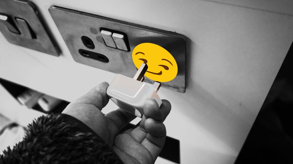electrical socket with smiles face sticker over it