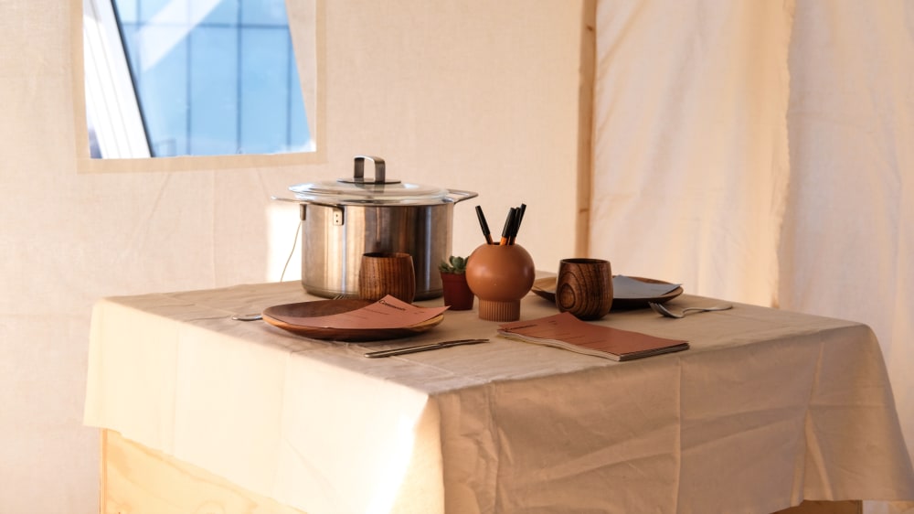 A table with plates and a cooking pot