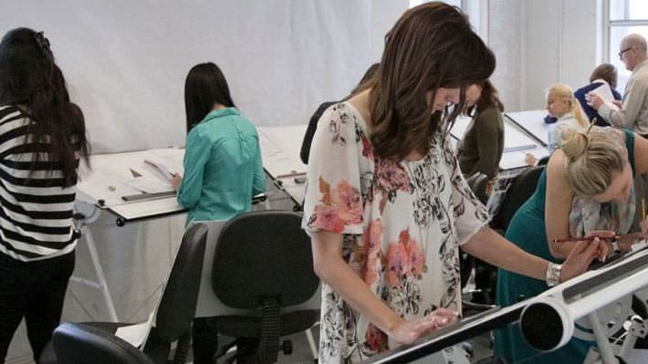 Photo of a woman working at an angled desk