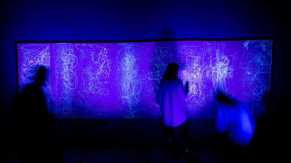 People drawing in the dark