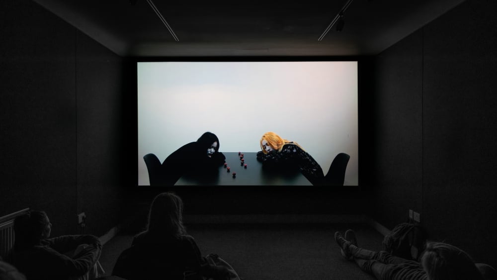 Two people resting their heads on a table 
