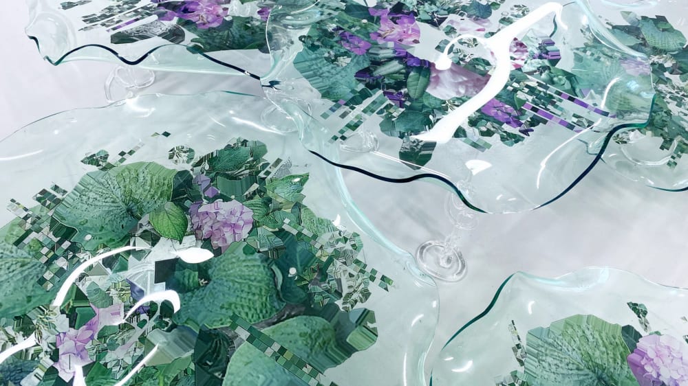 Images of a garden printed onto glass sculptures