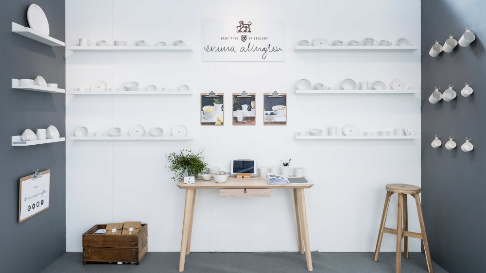 Exhibition space with white ceramic cups on display.