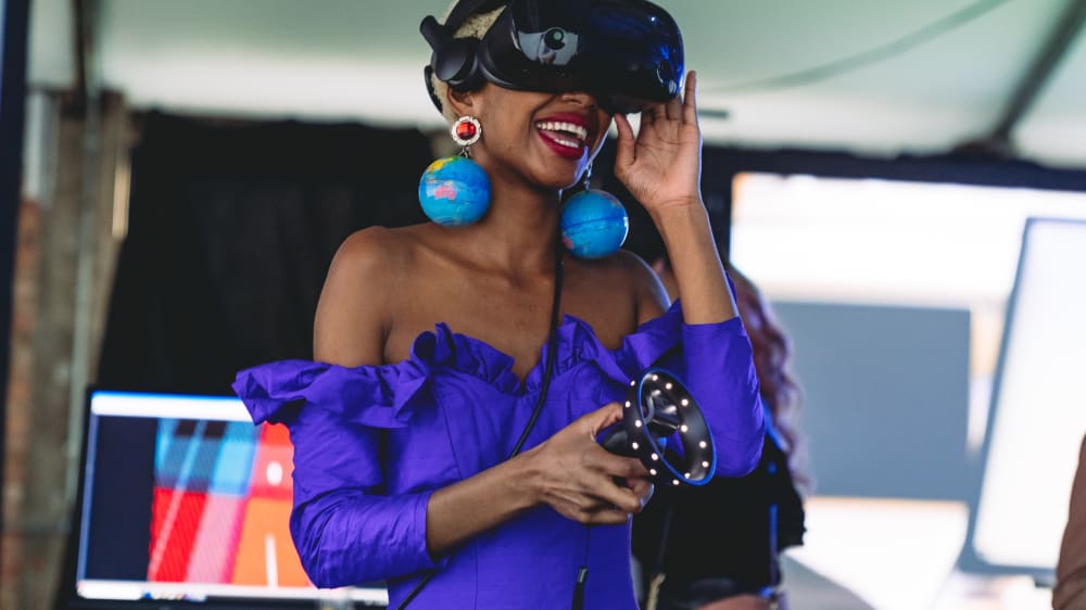 Student in a VR headset, wearing big globe earrings