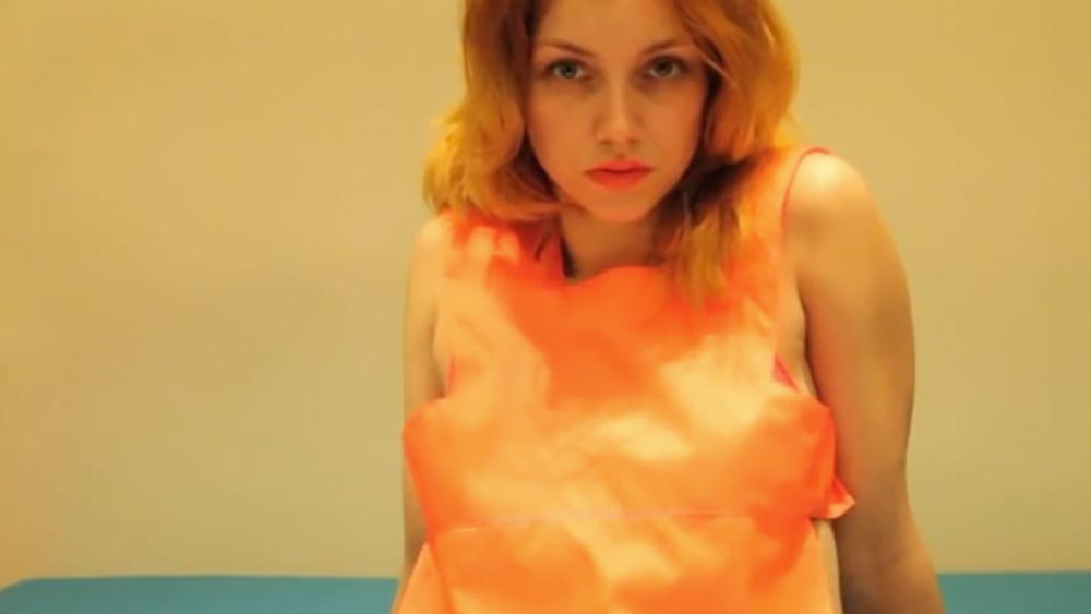 A woman in an orange top
