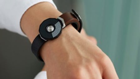 A modern watch strapped on a persons arm