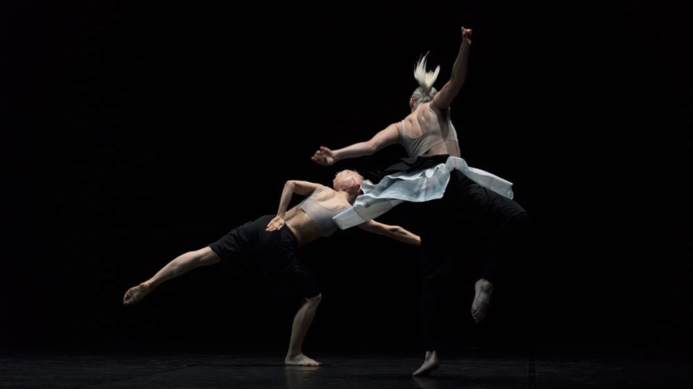 Two people dancing on a stage