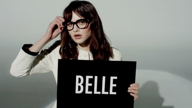 Corinne holding a sign that says 'Belle'
